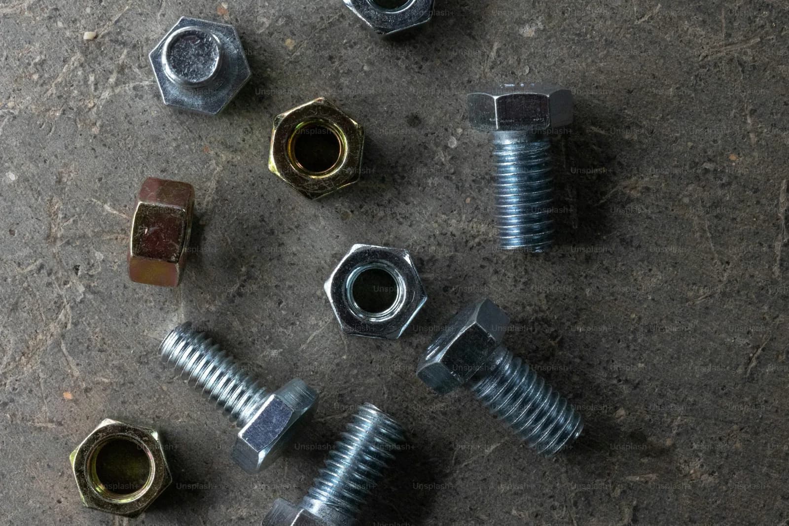 Metal nuts and bolts laid out for checking